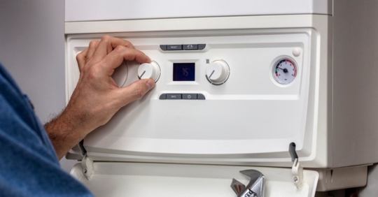 technician adjusting boiler