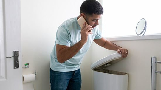 man fixing his own toilet