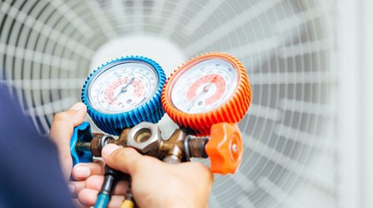 home service man checking ac units with tool