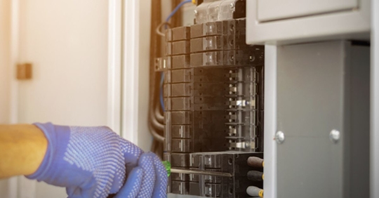 electrician working on electrical panel