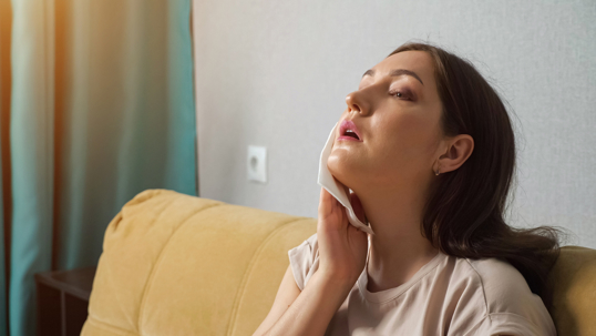 woman wiping her face with a cloth